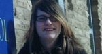 A small photo of Destiny as a teenager with long brown hair and glasses, in front of a stone wall.