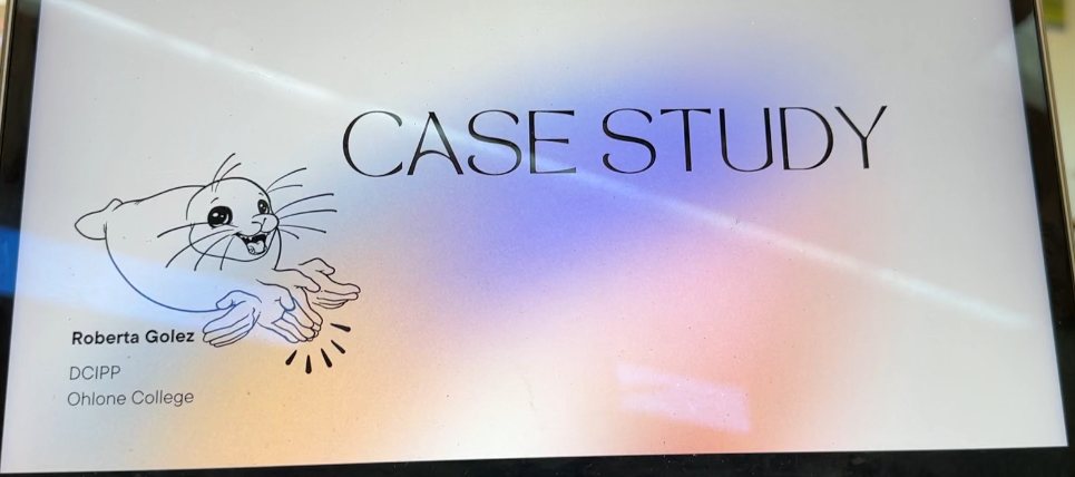 A laptop screen shows a presentation slide titled "Case Study", with the black line art of Sally the Seal signing SEAL beside the title, and the words "DCIPP" and "Ohlone College" below.